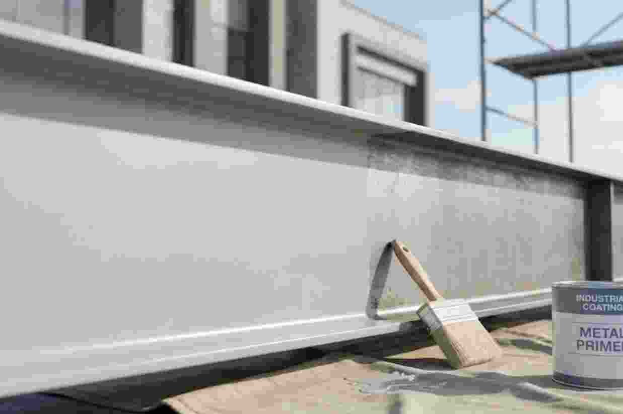 A steel beam with a can of metal primer during industrial painting
