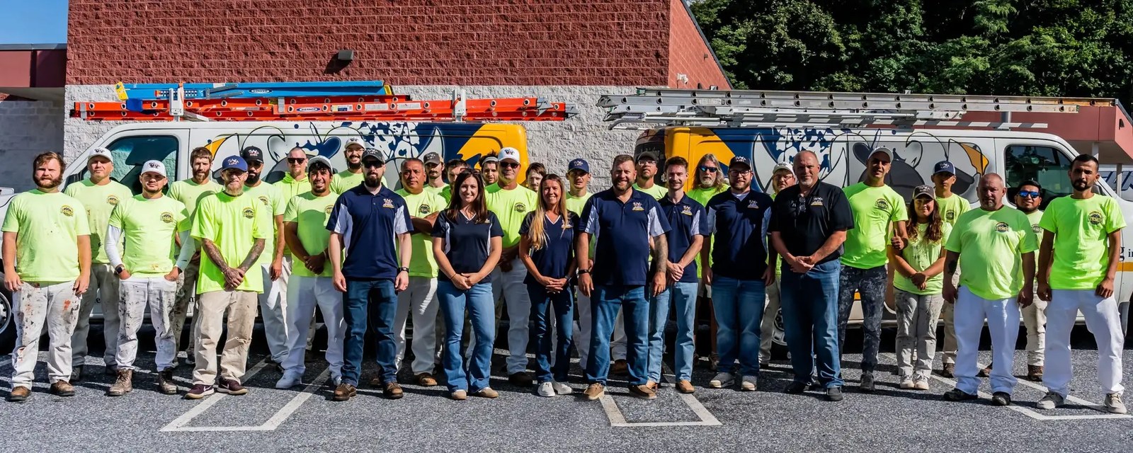 The full Anderson Pro Painting crew in matching shirts standing in a line